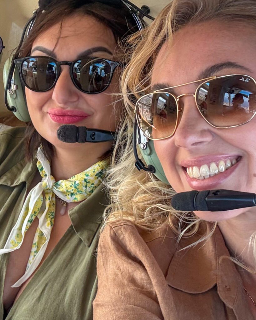 two smiling women on a helicopter flight in tenerife
